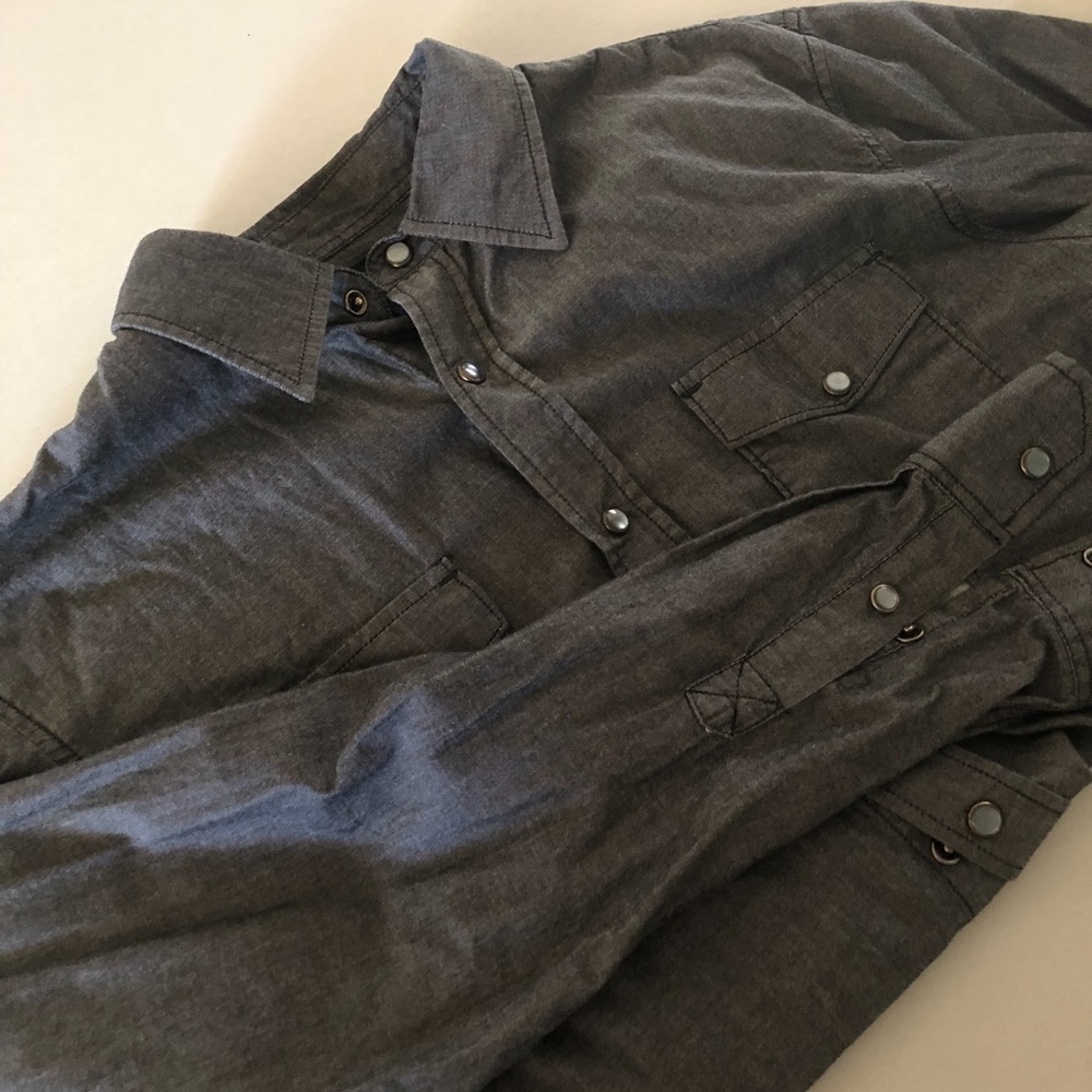 Grey snap button shirt.